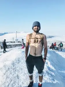 man without shirt in snow