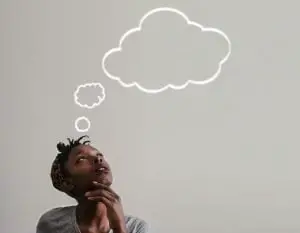 Black woman looking thoughtful with a white thought cloud above her head