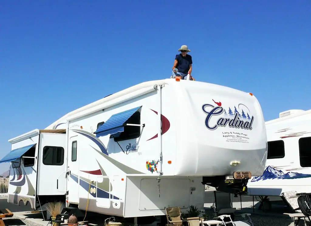 man washing RV