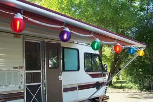 older model motorhome with colorful globe awning lights