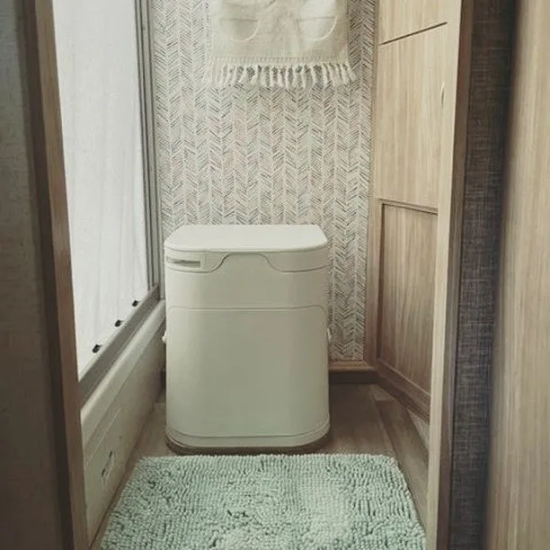An OGO Composting Toilet installed in a motorhome RV bathroom.