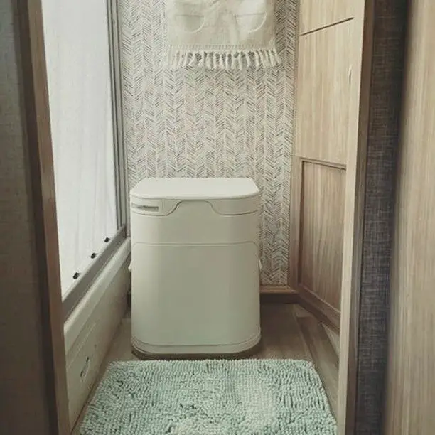 An OGO Composting Toilet installed in a motorhome RV bathroom.