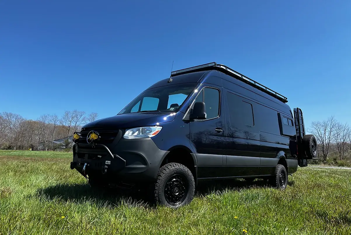 Black van conversion in a field