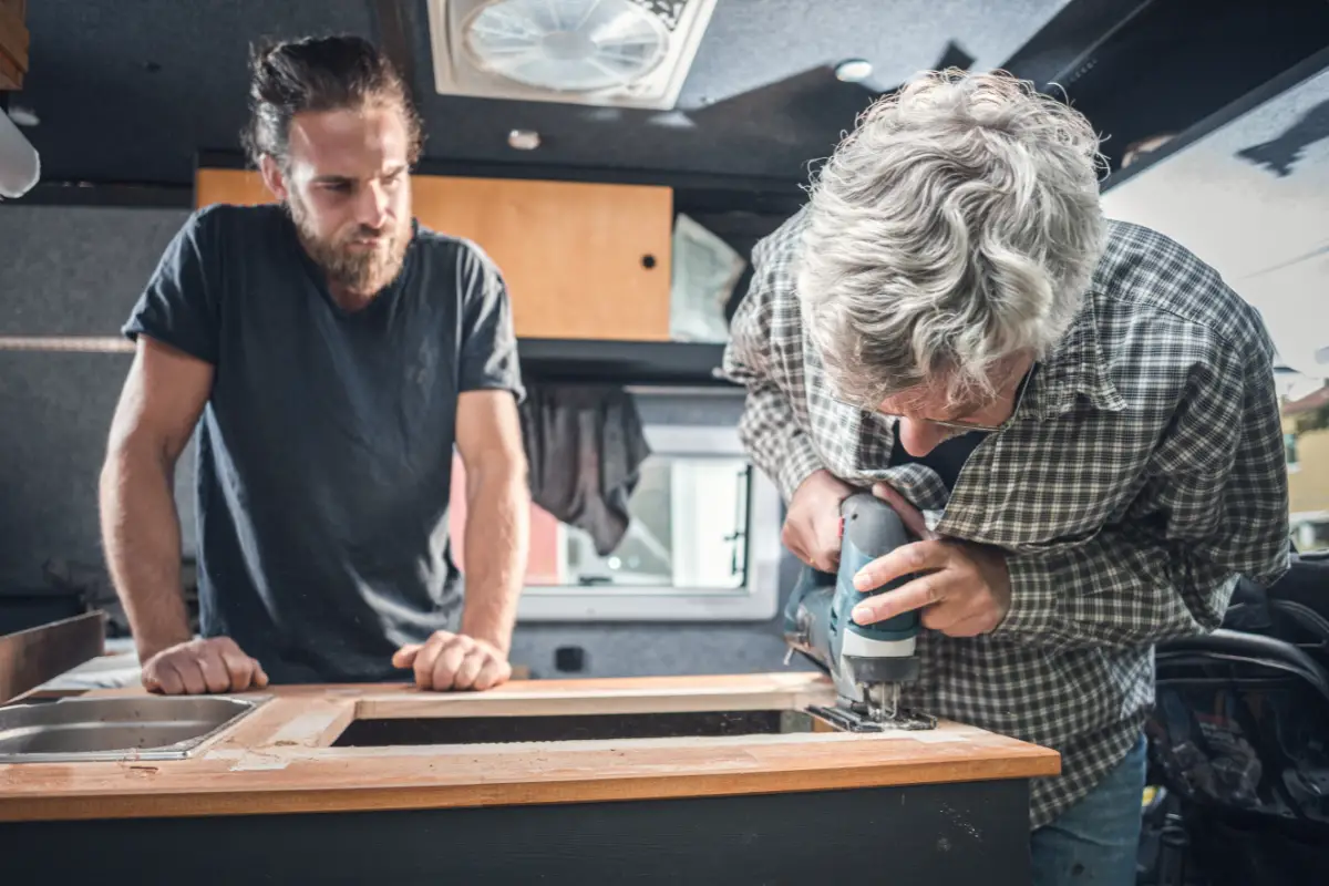 Two men working on a campervan conversion