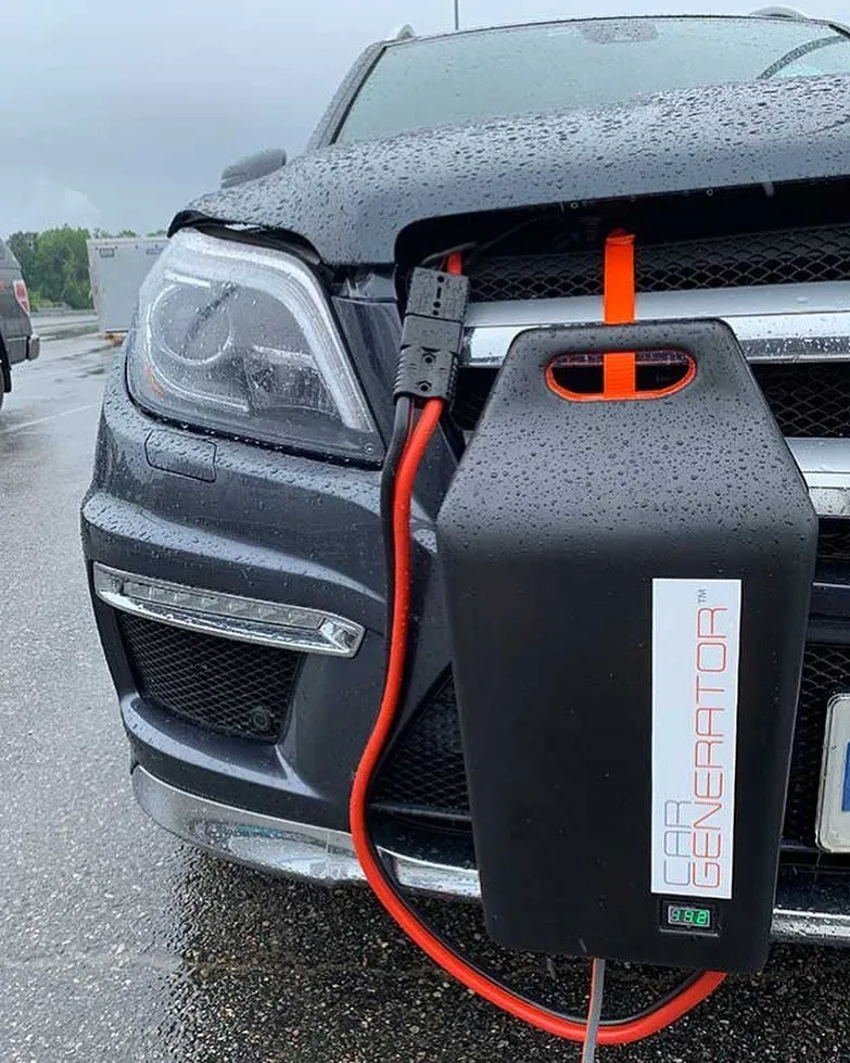 CarGenerator attached to the front of a small SUV on a rainy day